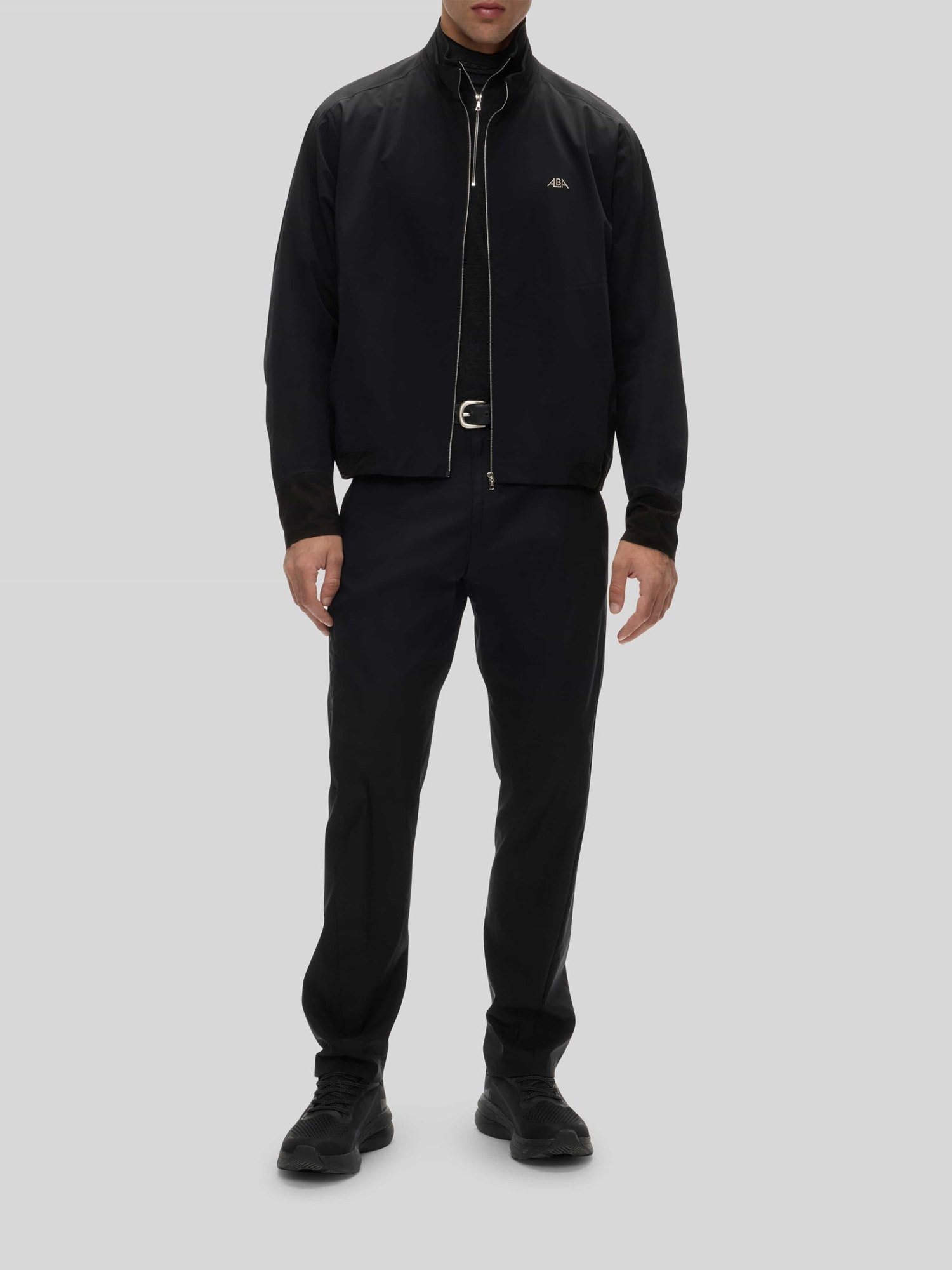 The black Crest Jacket with black trousers, full length
