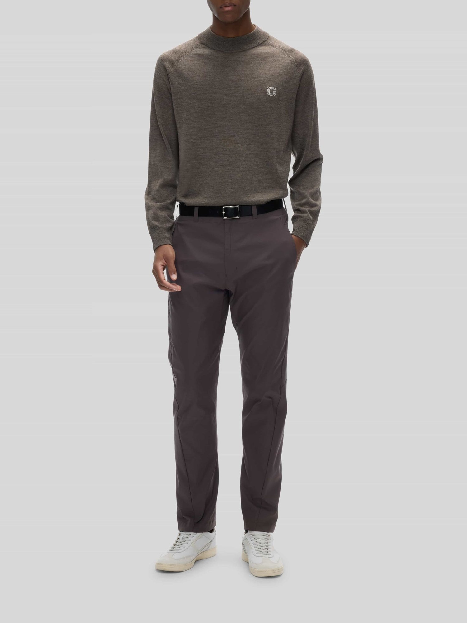 The Alba Cheviot mock neck in melange beige worn full length