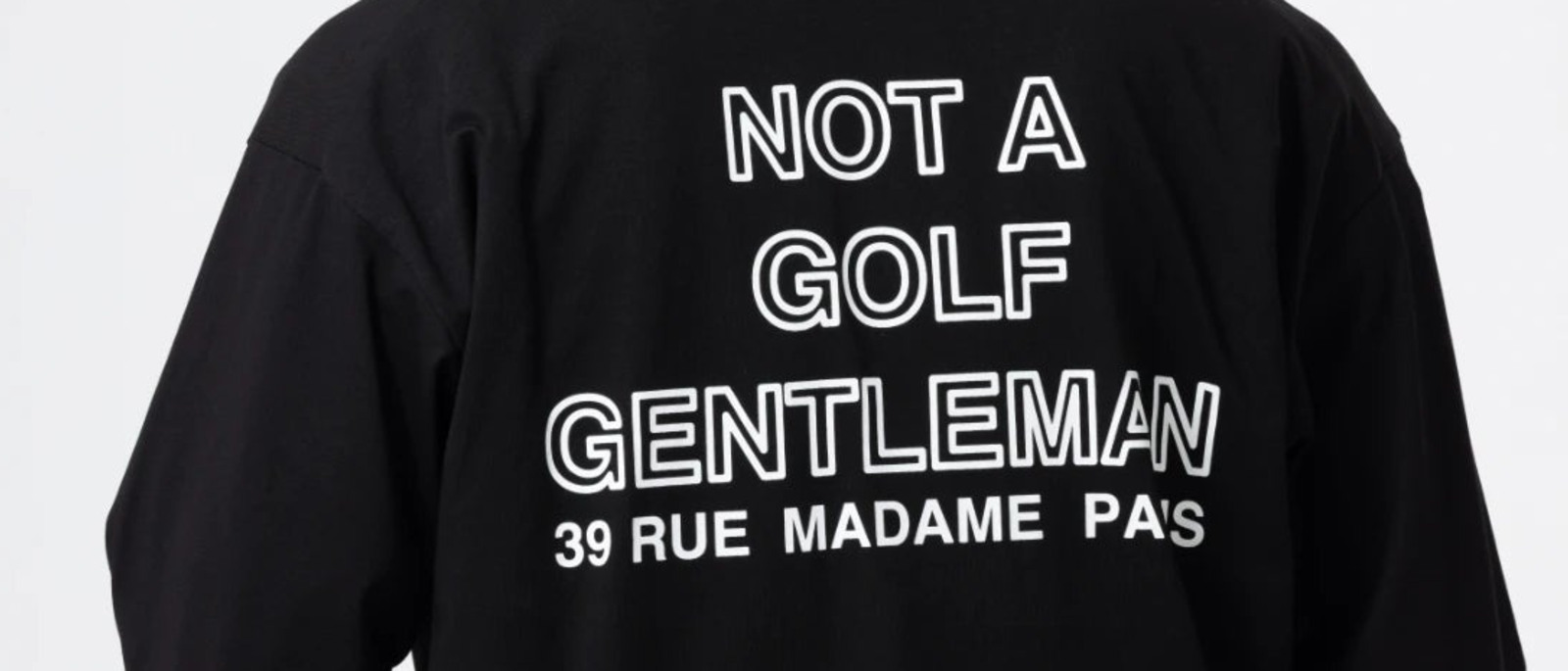 The back of the A.P.Cph/Golf half zip in black, printed NOT A GOLF GENTLEMAN above the address 39 RUE MADAME PARIS