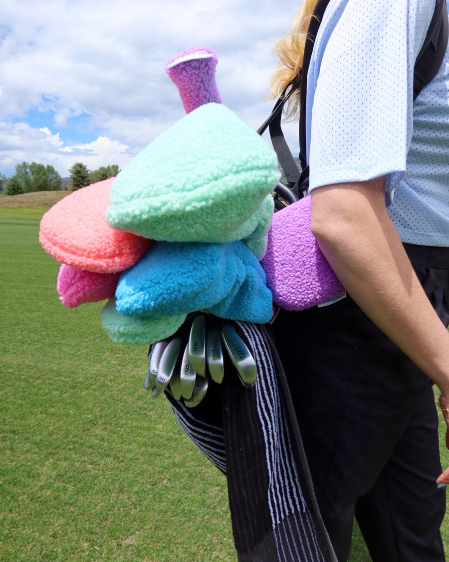 The @HallyLead neon covers loaded onto a carry bag beside a set of irons