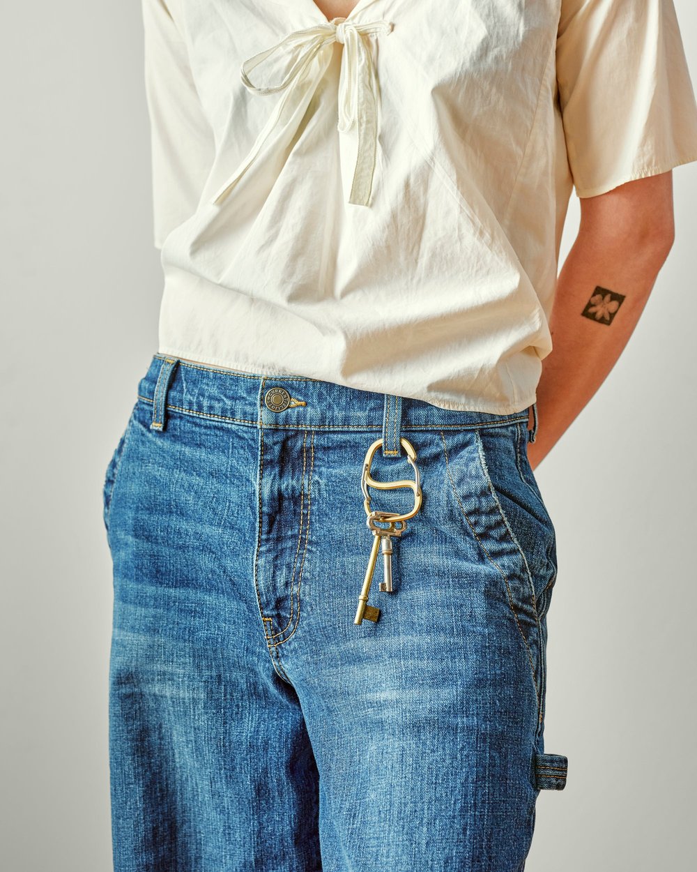 Keys clipped to the belt loop of a pair of jeans with a Craighill carabiner