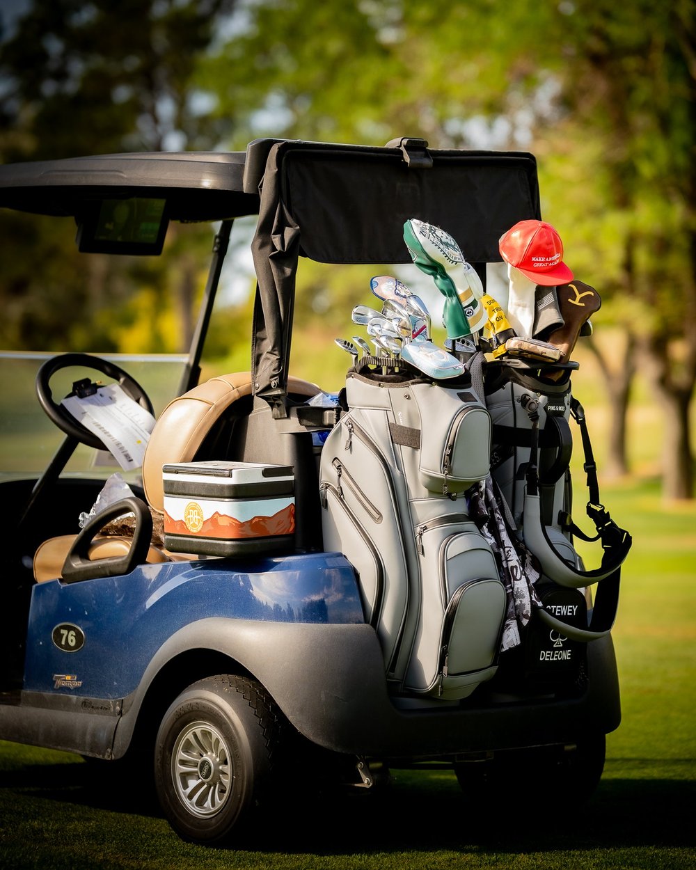 A cart bag on the back of a golf cart with a magnetic rangefinder