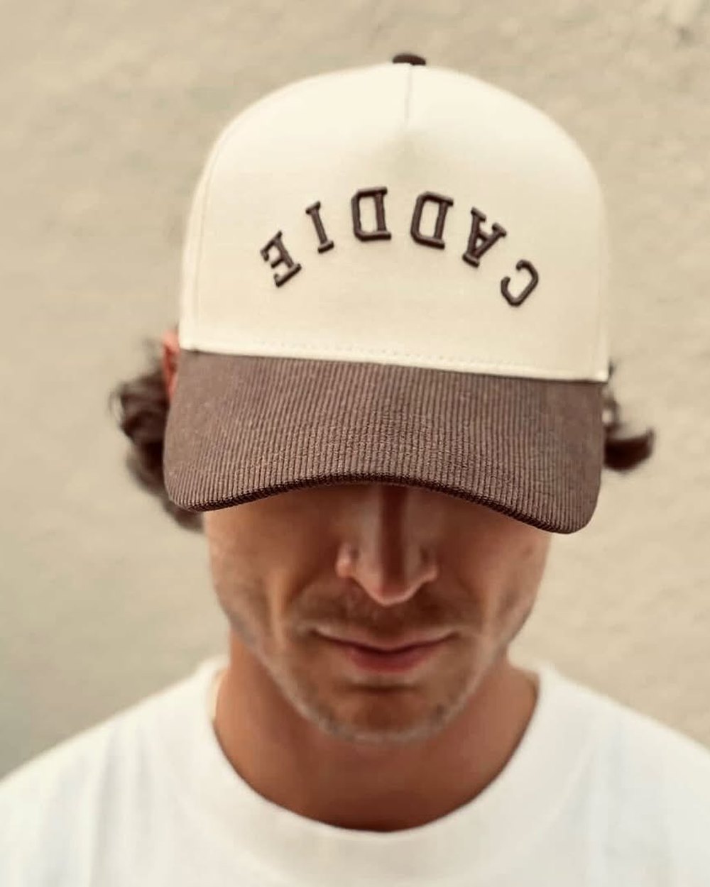 A man with the Caddie hat pulled low over his eyes