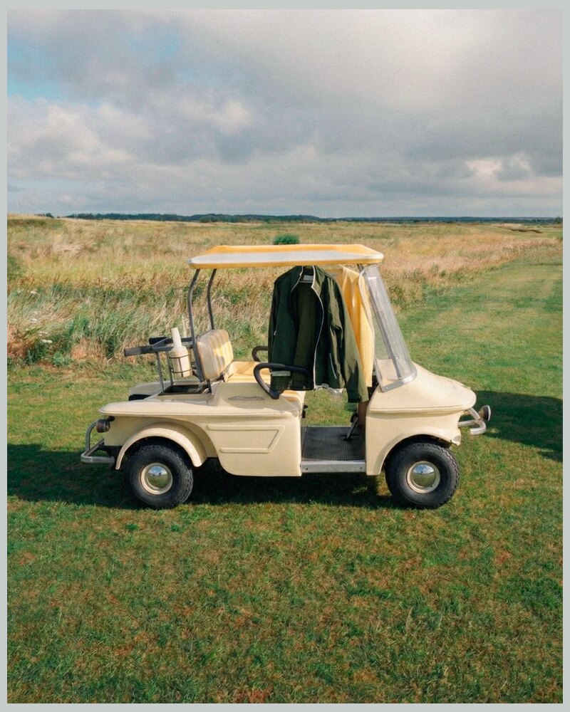 Casualist Beach Rover cream golf cart with yellow striped canopy on a links course