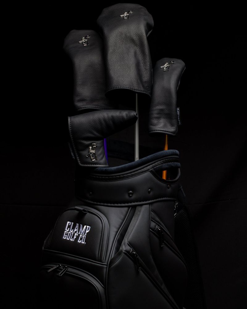 A black Clamp golf bag with matching black leather covers