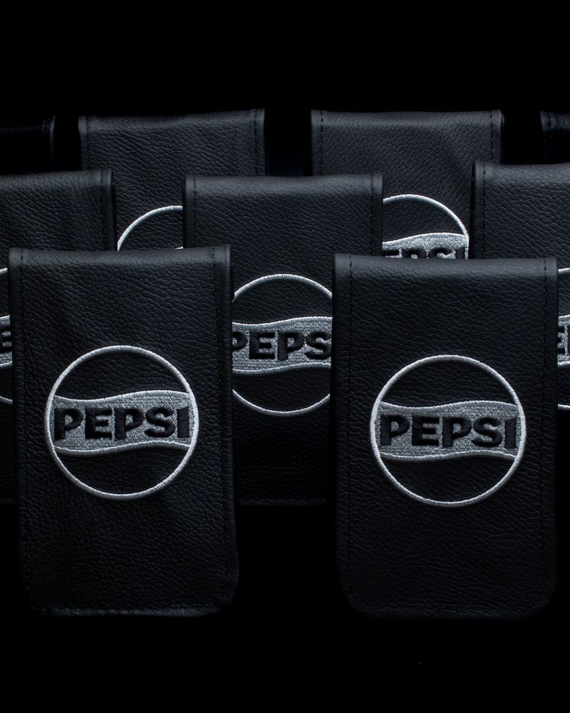 Black Pepsi-branded pouches made by Clamp