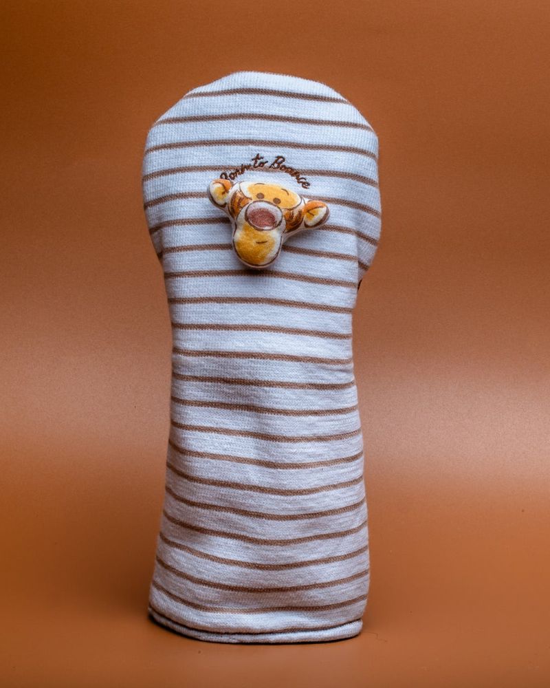 A striped headcover with a small tiger mascot on top