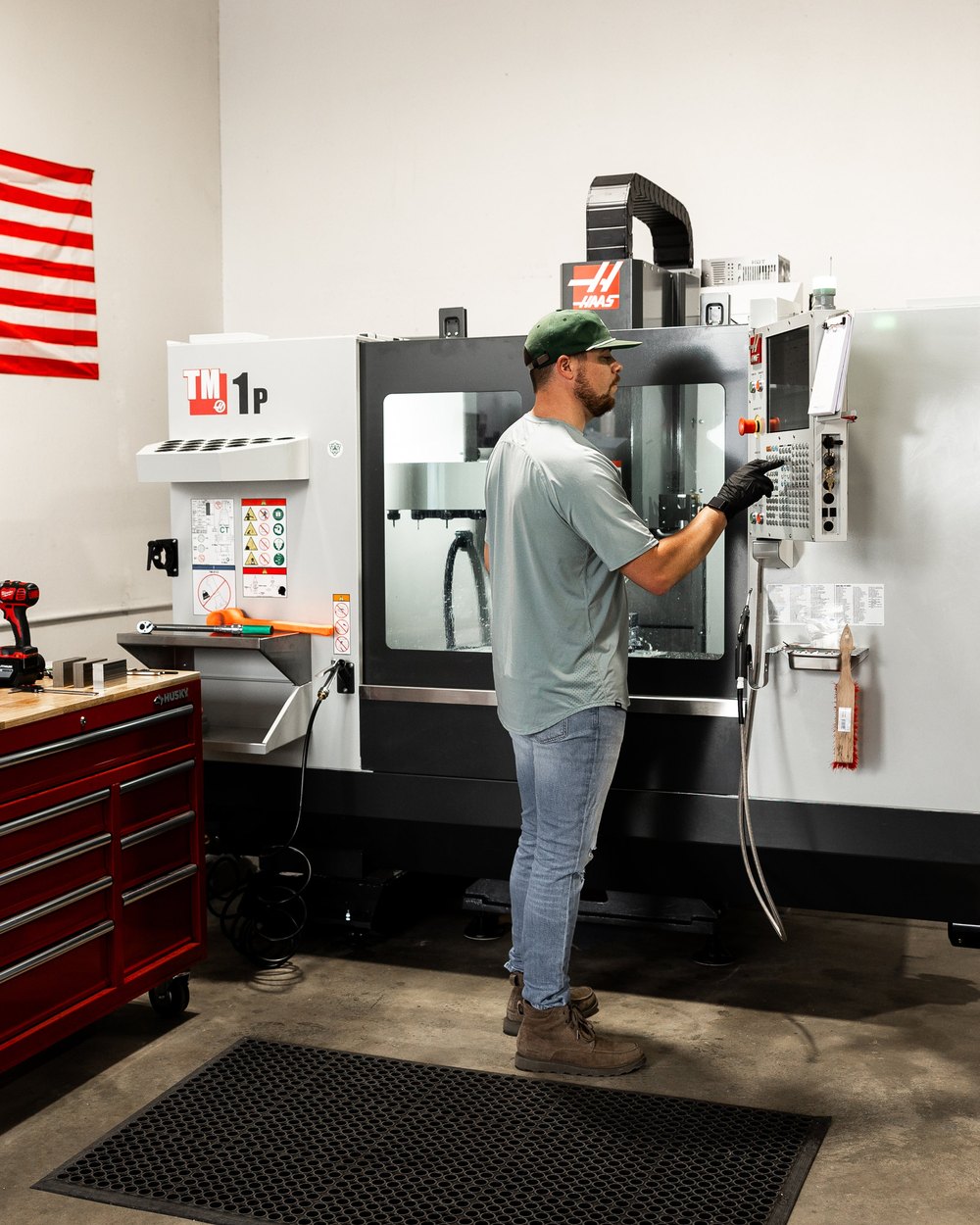 Hanna Golf's machine shop with an American flag on the wall