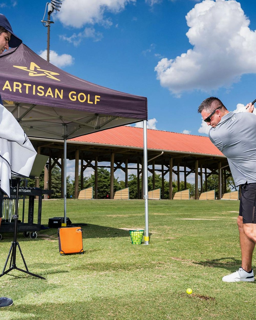 An Artisan Golf fitting tent on a driving range
