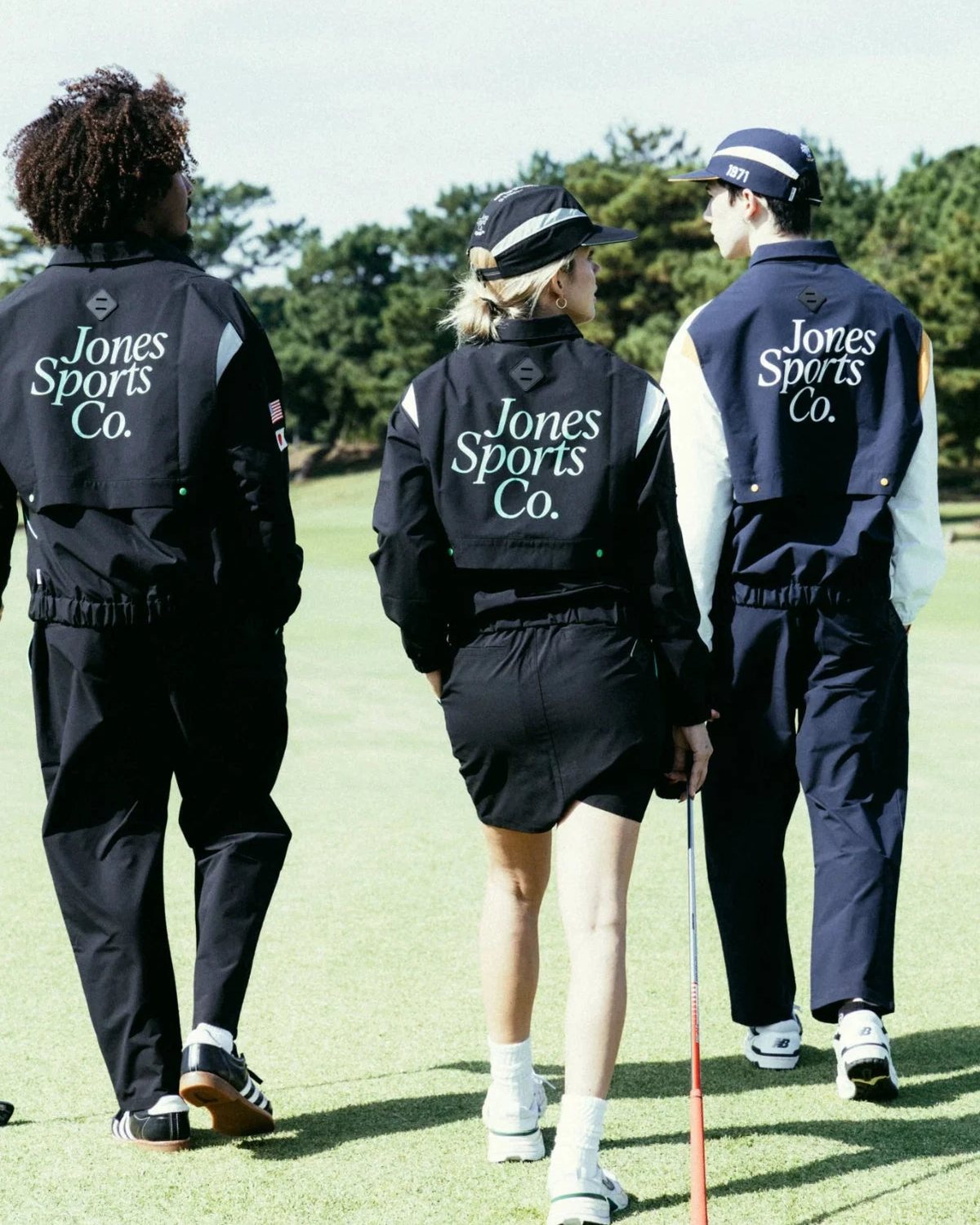 Three players seen from behind with Jones Sports Co. across their jackets