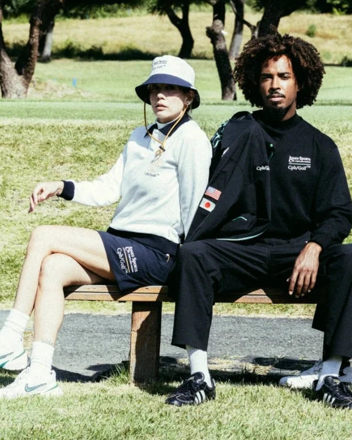 Two players sitting on a bench beside a fairway, from Cph/Golf&rsquo;s lookbook for the Jones collaboration