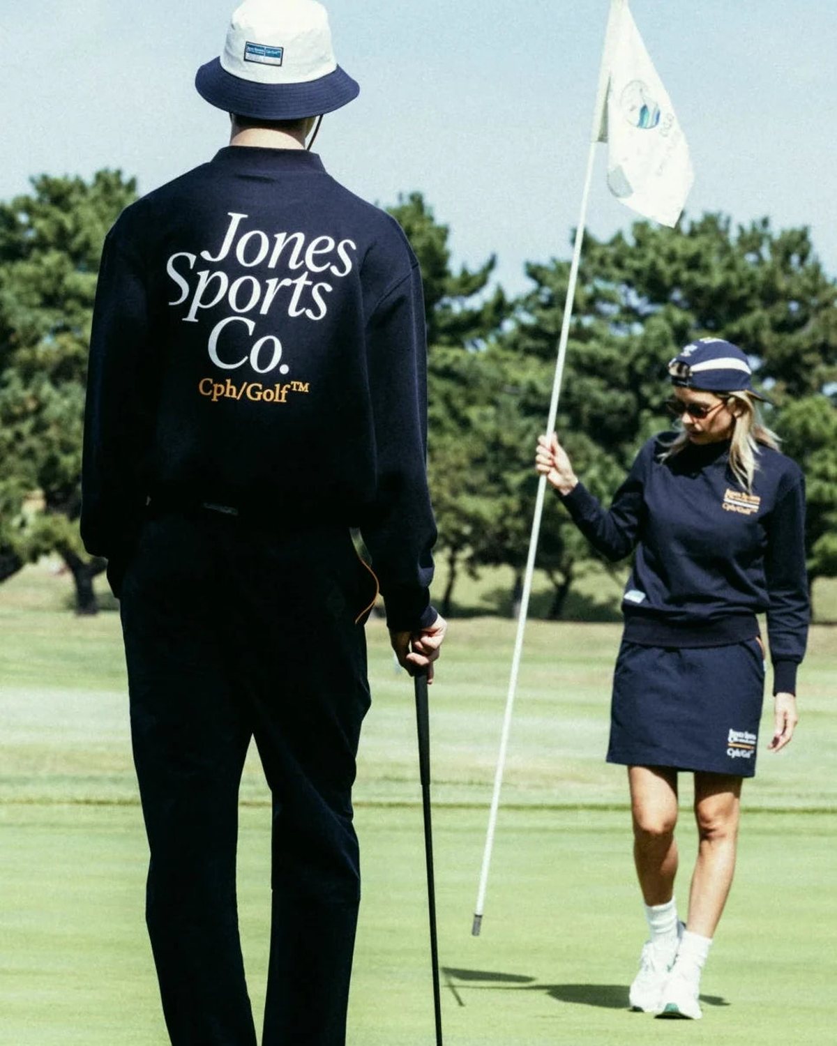 A player in the navy jacket by the flagstick, from Cph/Golf&rsquo;s lookbook for the Jones collaboration