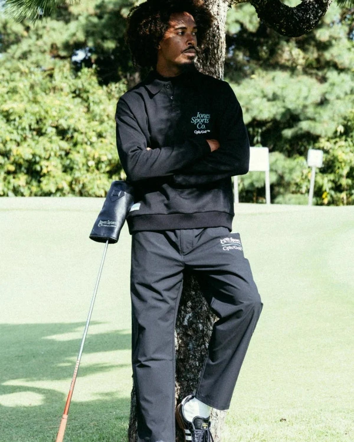 A player in a black mock neck holding a club, from Cph/Golf&rsquo;s lookbook for the Jones collaboration