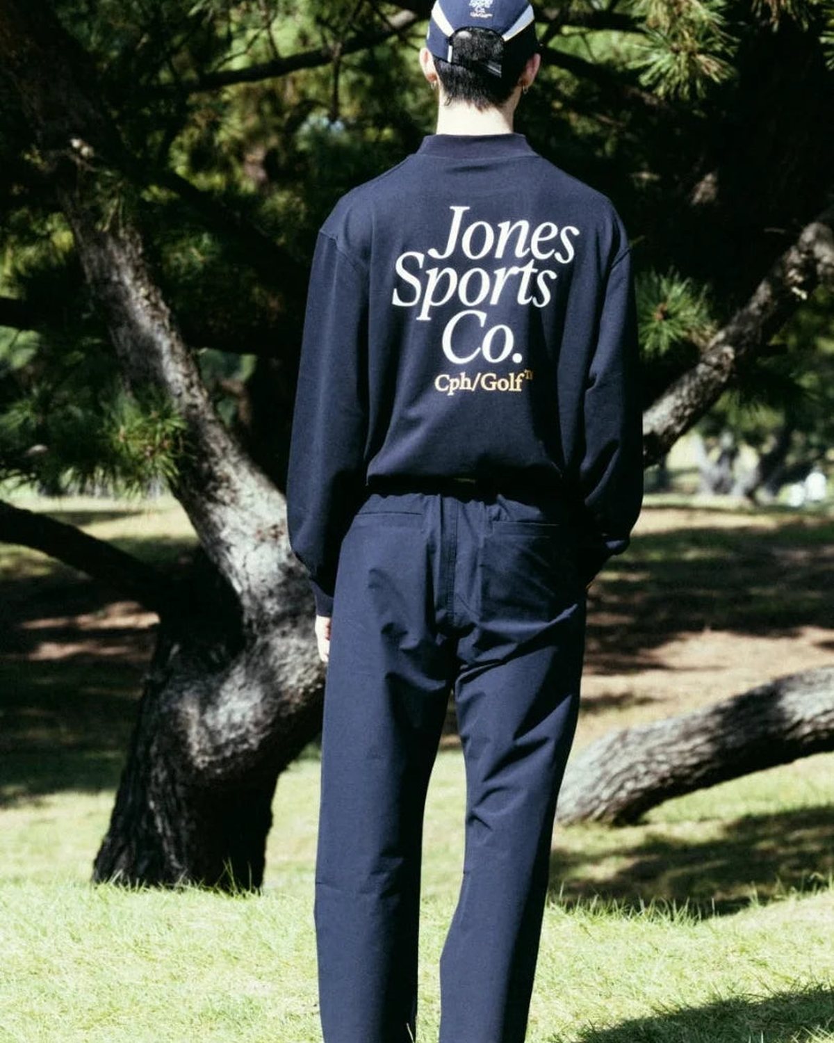 A player in the navy jacket seen from behind, from Cph/Golf&rsquo;s lookbook for the Jones collaboration