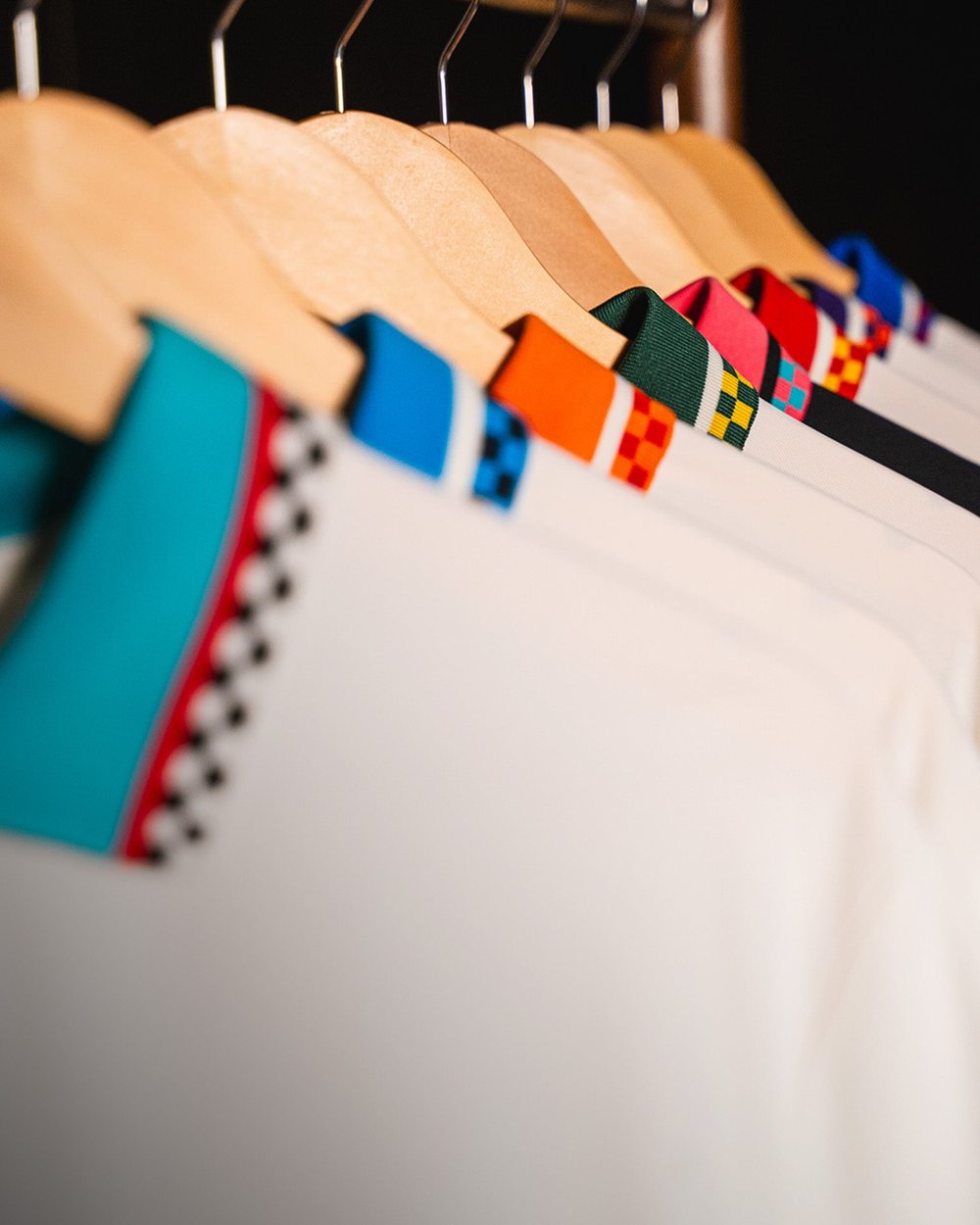 Close-up of Draft Day polo collars in orange, green, blue and pink