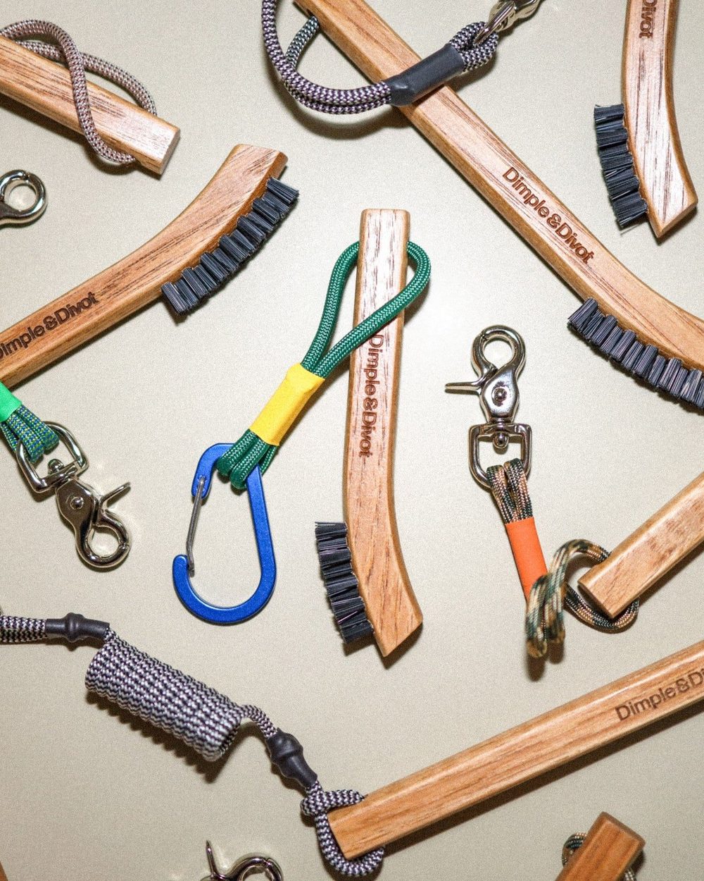 Dimple & Divot hickory brushes laid out with their coloured tethers and nickel snaps