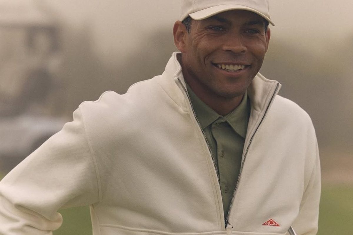 A golfer in a cream SLOAT quarter zip on a foggy course