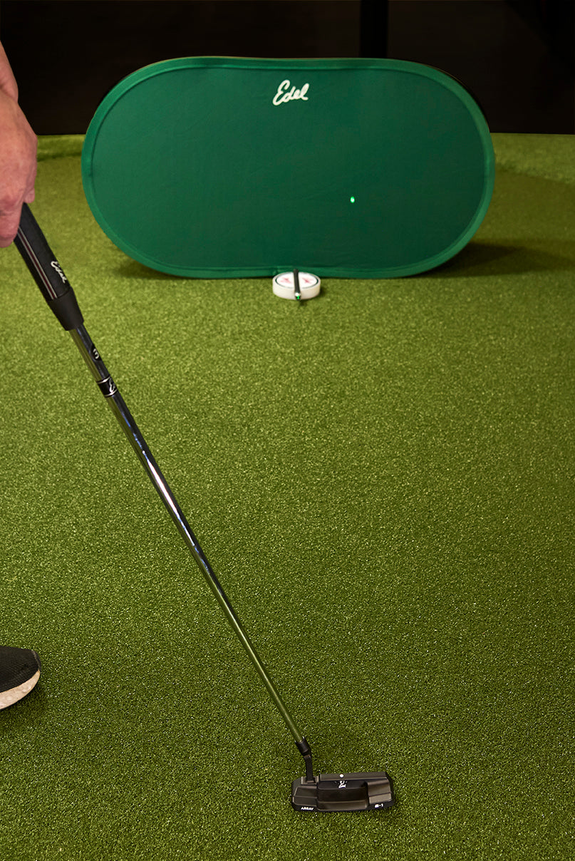 Edel's Aim Check laser alignment kit set up on a practice green