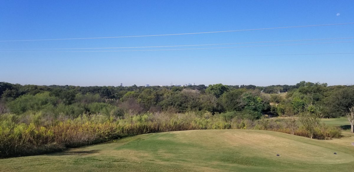 View of downtown Austin skyline from a tee box at Morris Williams Golf Course