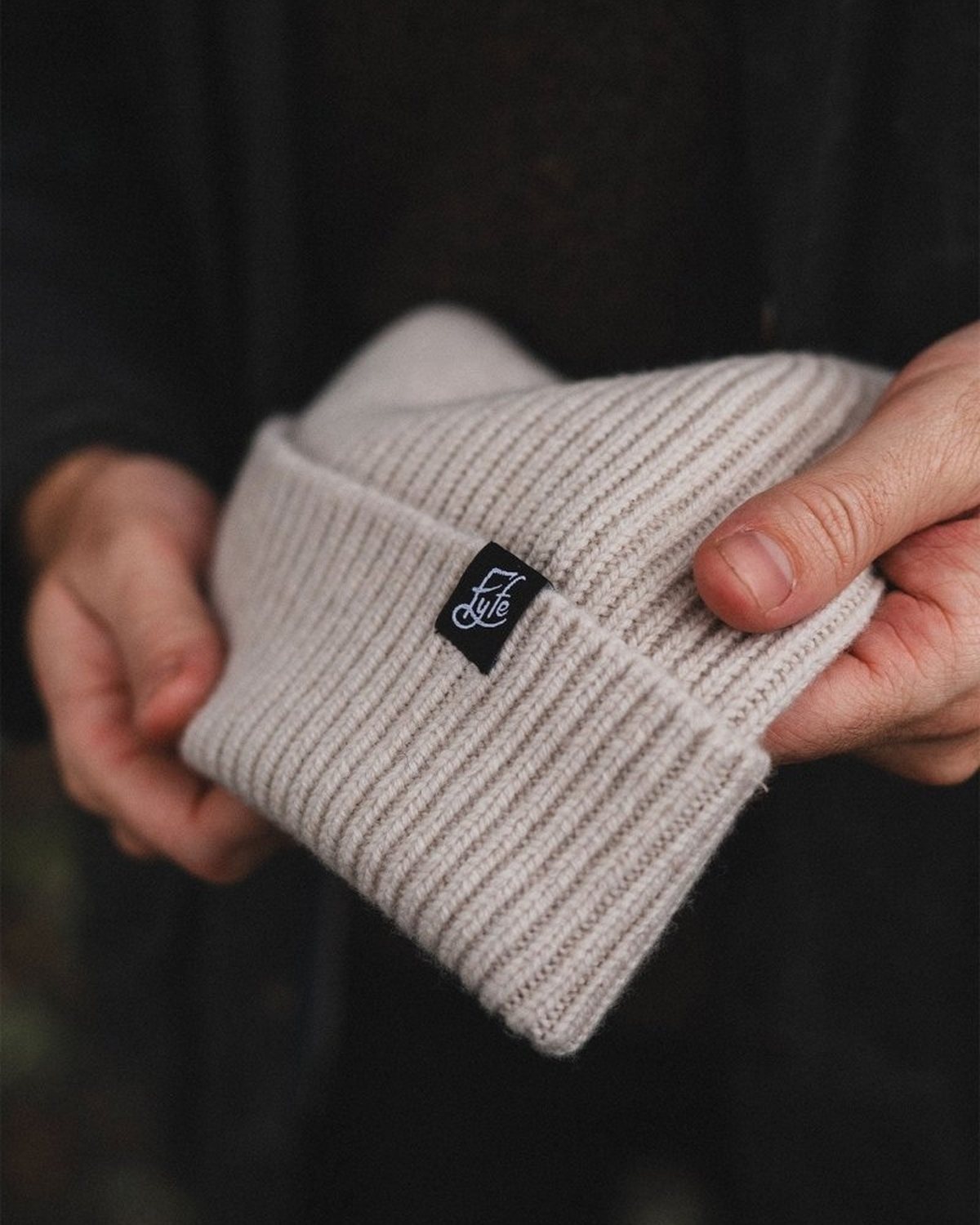 Hands holding a Fyfe merino beanie