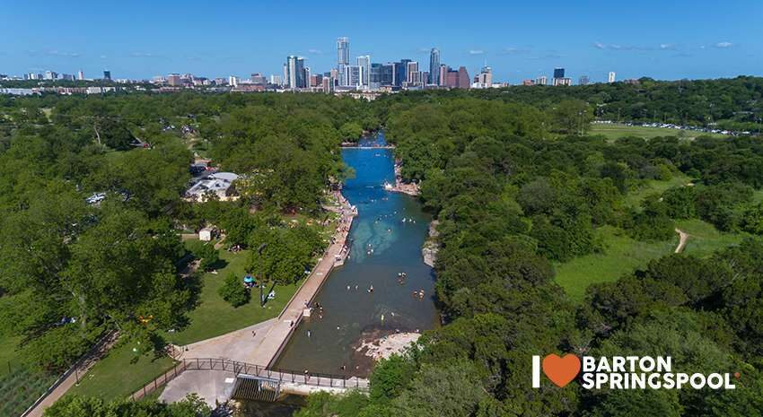 Barton Springs Pool — aerial view with Austin skyline