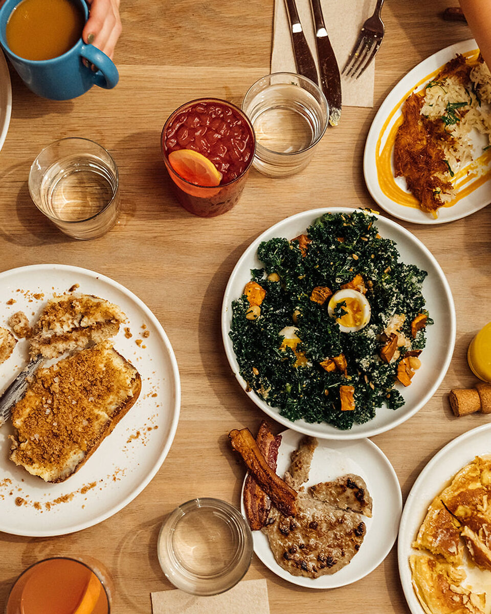 Paperboy Austin — overhead view of brunch dishes and cocktails