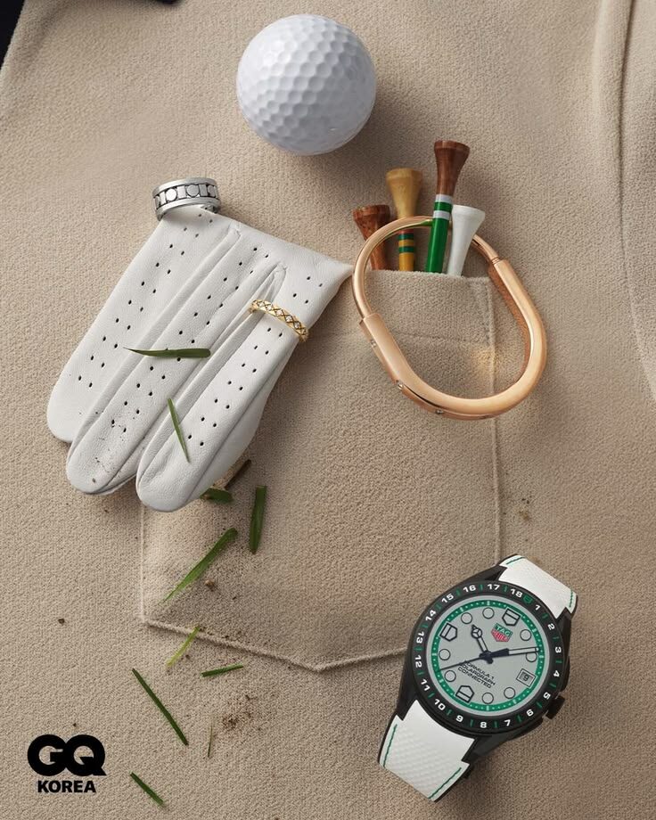 Editorial flat lay with golf glove, watch, ball, and wooden tees on beige canvas