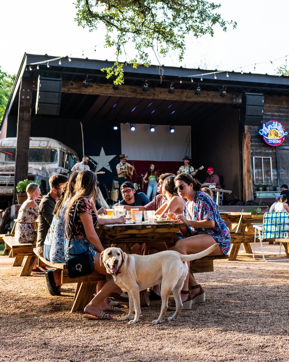 Armadillo Den — outdoor bar under the oaks