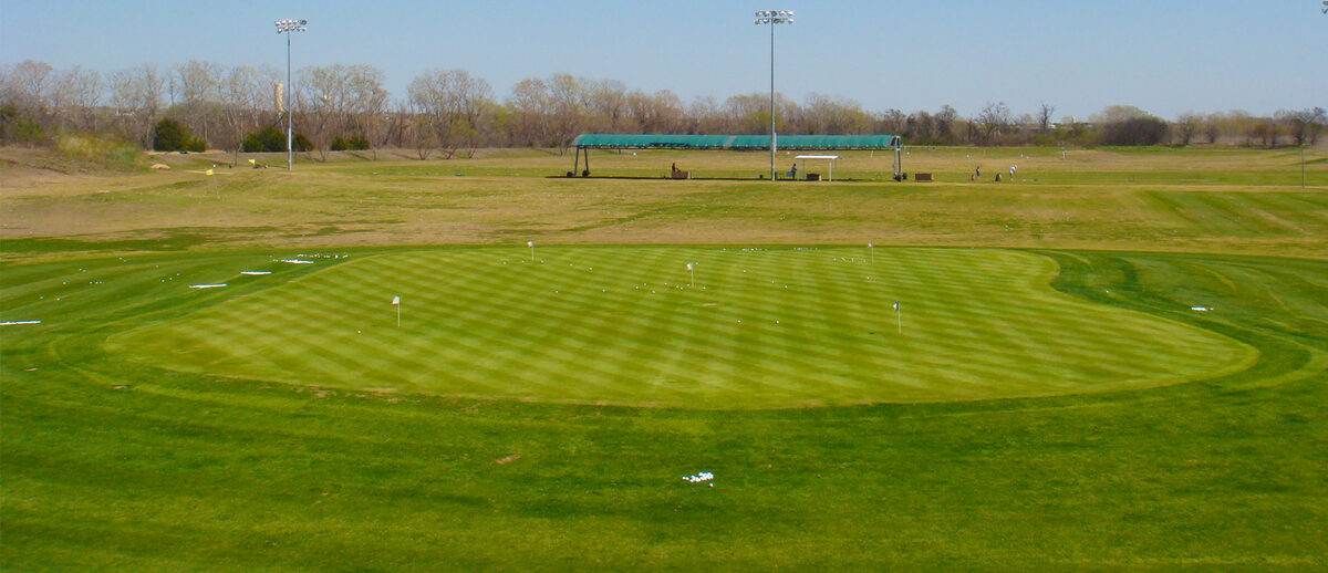 The Driving Range Round Rock — chipping green and lighted range