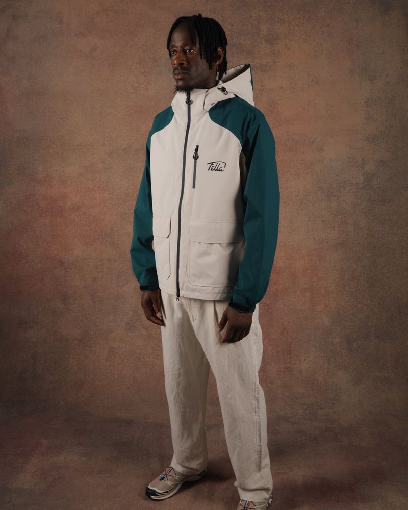 A model in the green and off-white Panel Tech Jacket