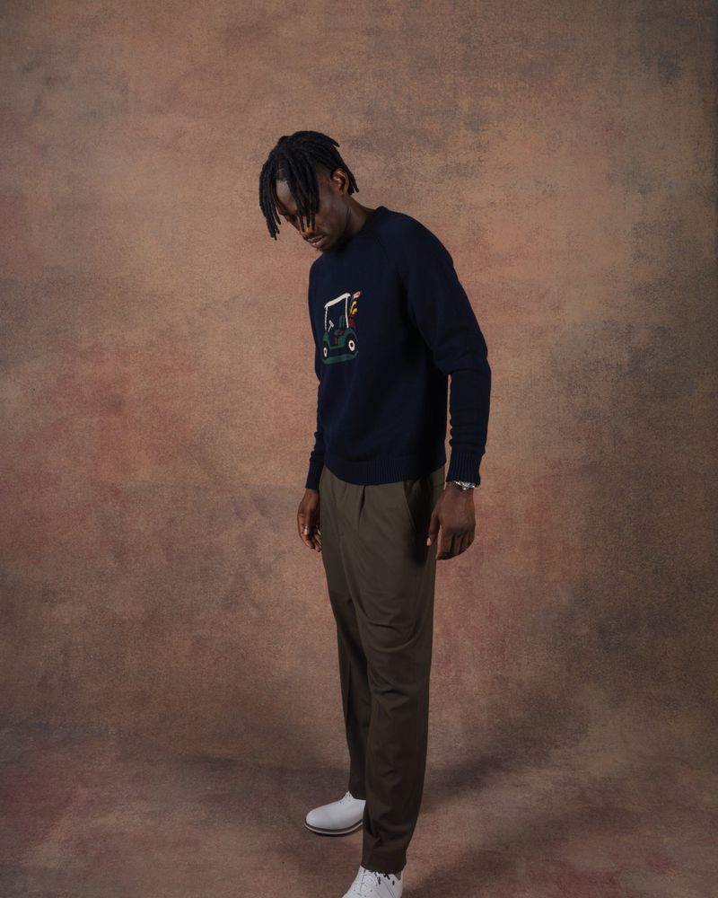 A model in the navy Graham golf cart knit