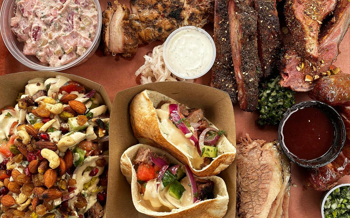 Sliced brisket and smoked ribs on butcher paper at an Austin BBQ joint