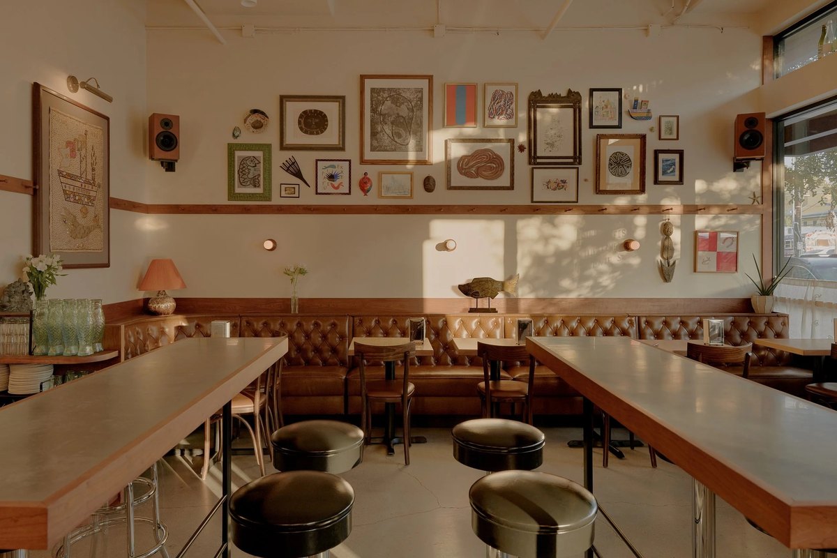 Fish Shop&rsquo;s dining room in East Austin, with leather banquettes and framed art