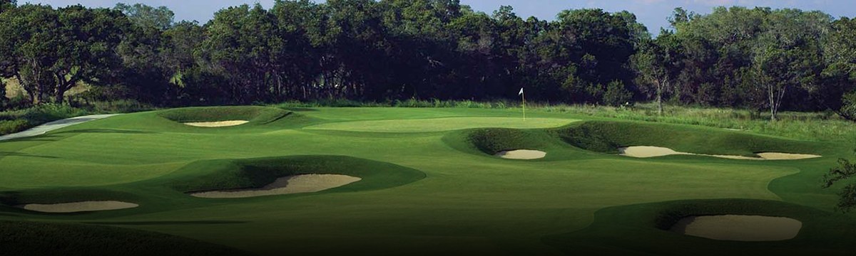 Bunkered green set into Hill Country woodland on the Canyons Course at TPC San Antonio