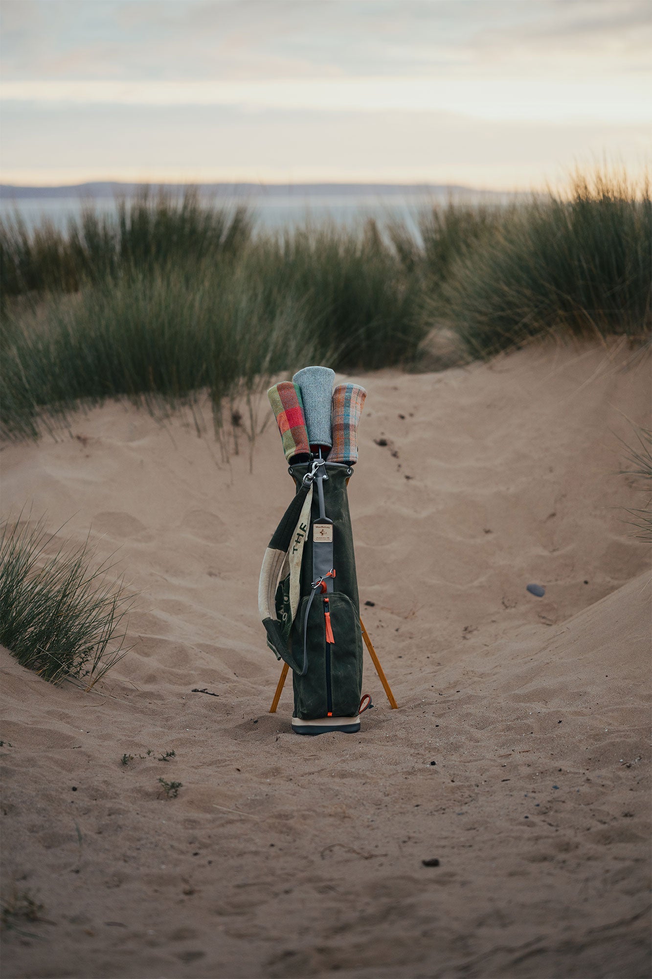 A MacKenzie x Fyfe limited edition bag standing in the dunes