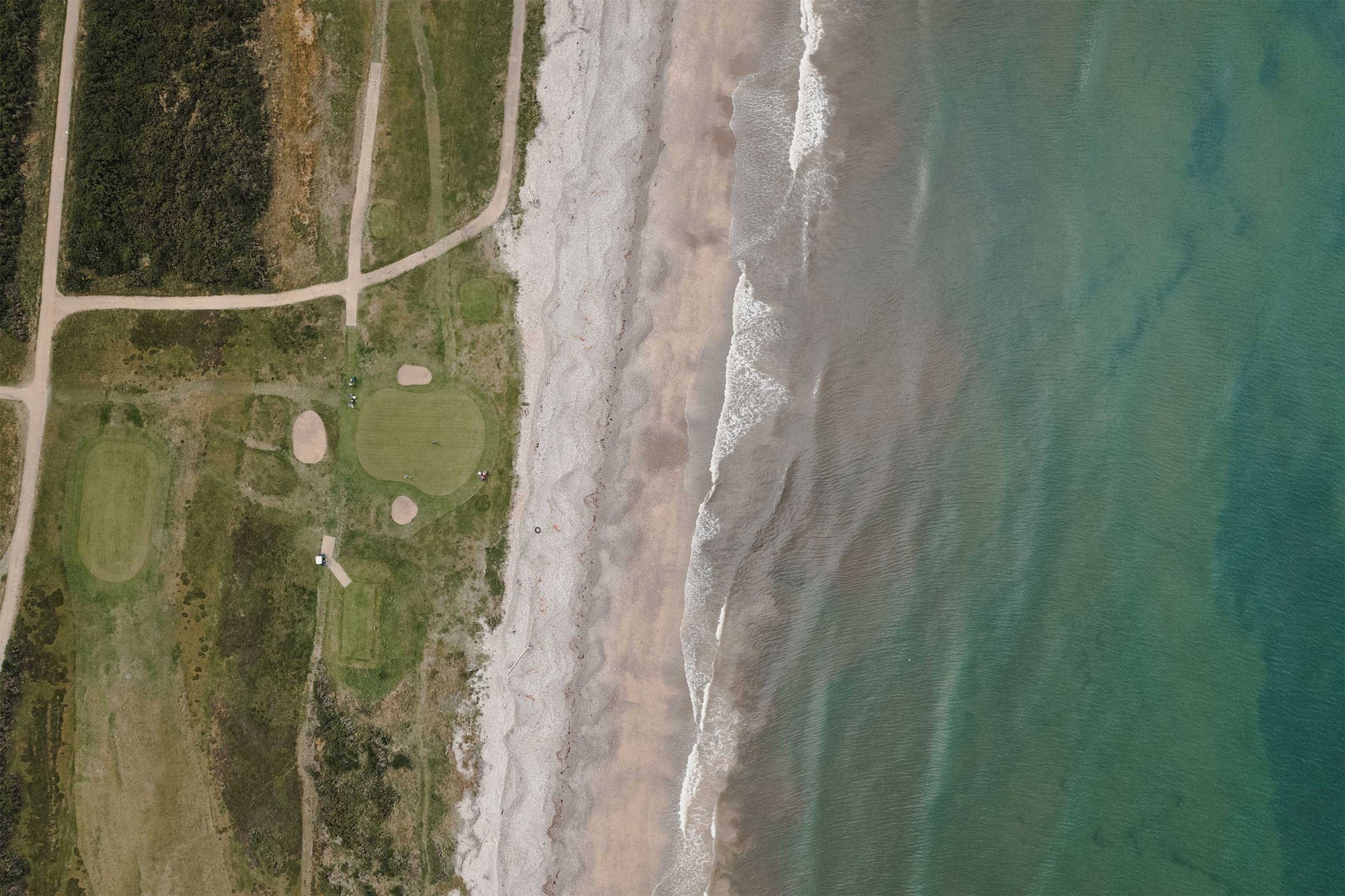 An overhead frame of the green complex at Spey Bay, sea and beach beyond