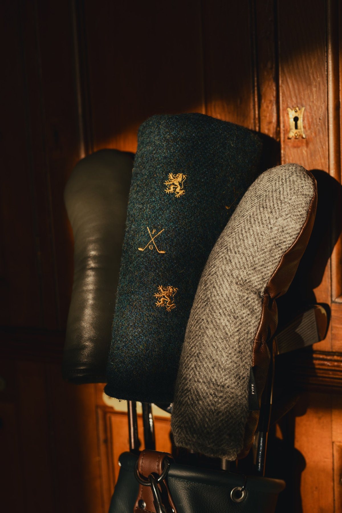 Harris Tweed headcovers in a leather bag in the locker room