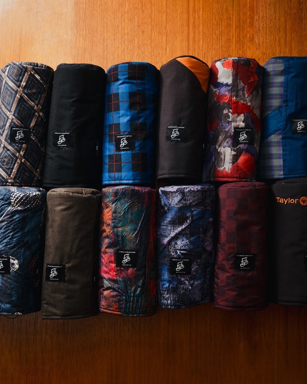 Fyfe Golf Second Round headcovers lined up on a wooden table
