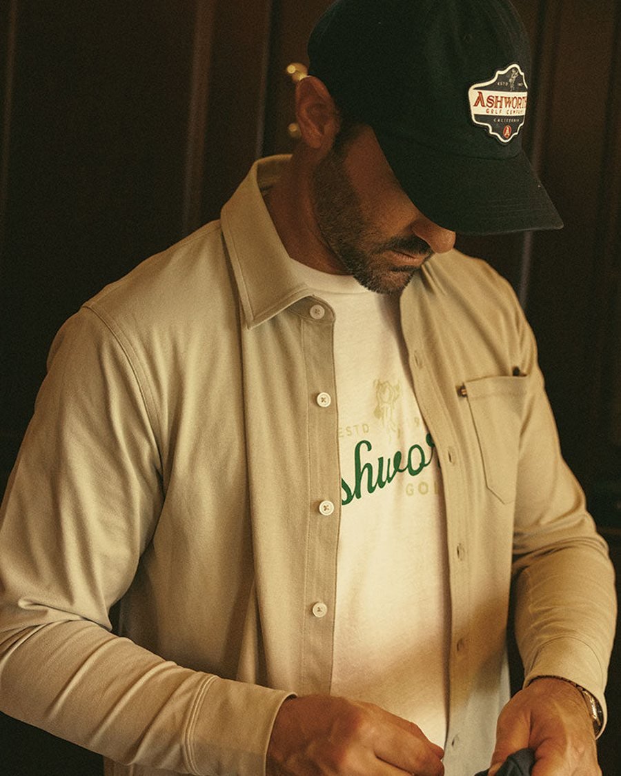 A golfer in an Ashworth overshirt and cap