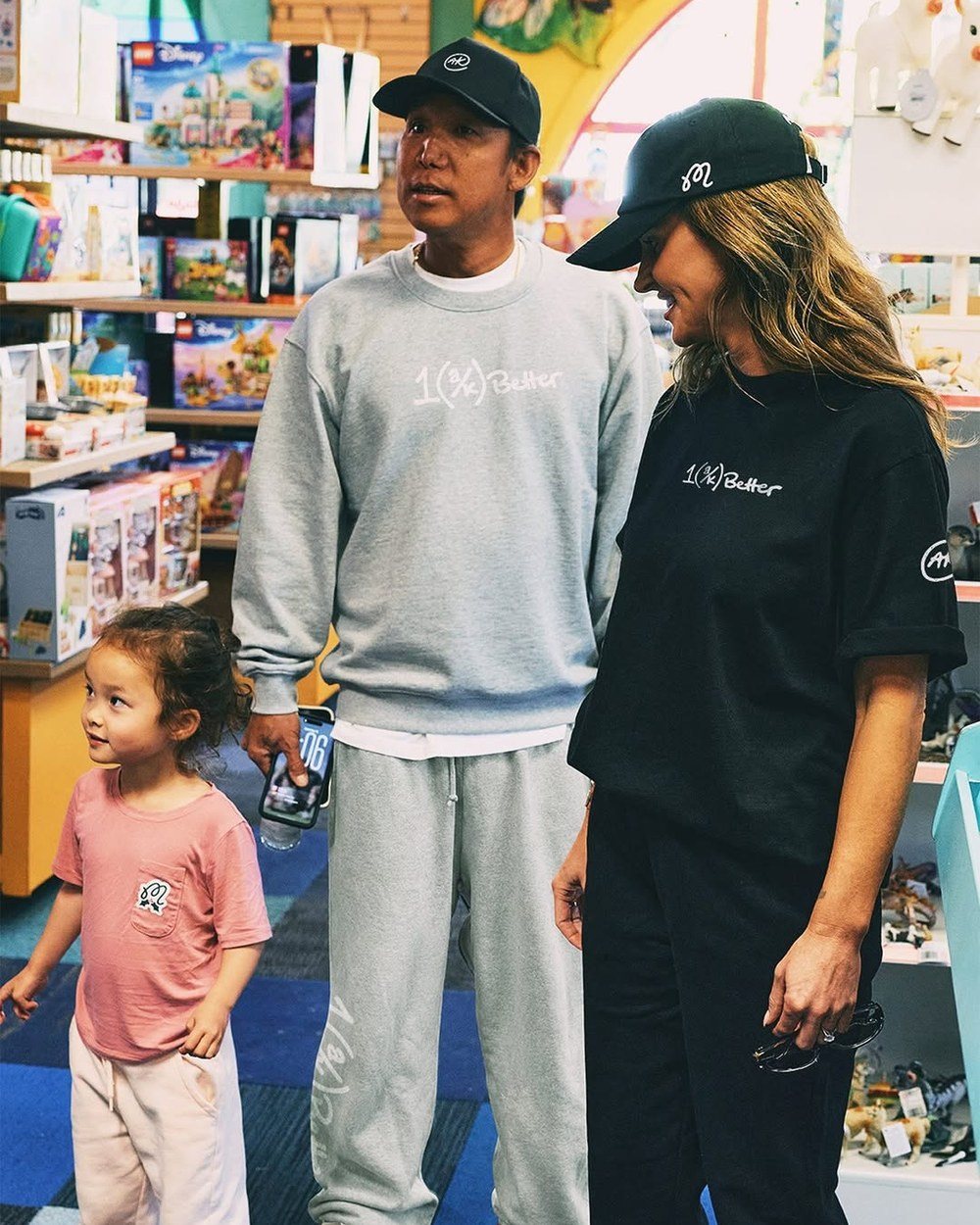 Anthony Kim in a grey 1% Better sweatsuit with his family