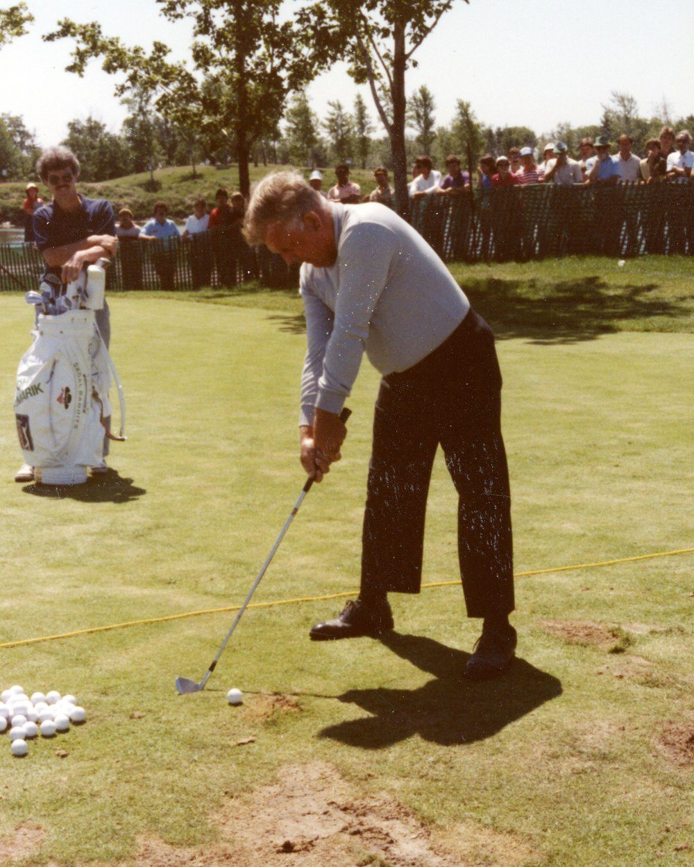 Moe Norman at address on the range in a light sweater