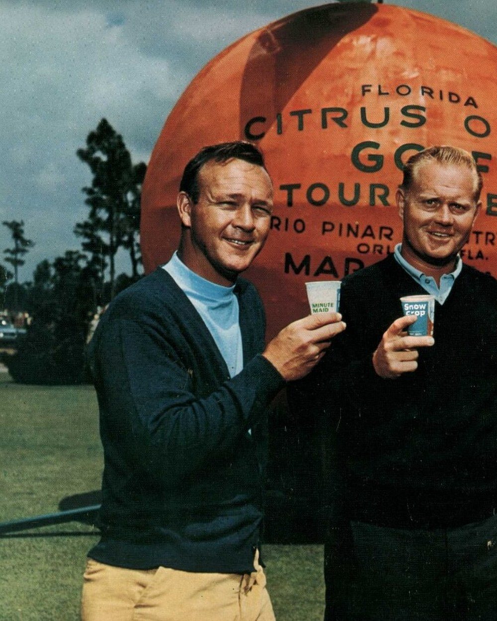 Arnold Palmer in a navy cardigan over a light blue mock neck with Jack Nicklaus at the Florida Citrus Open