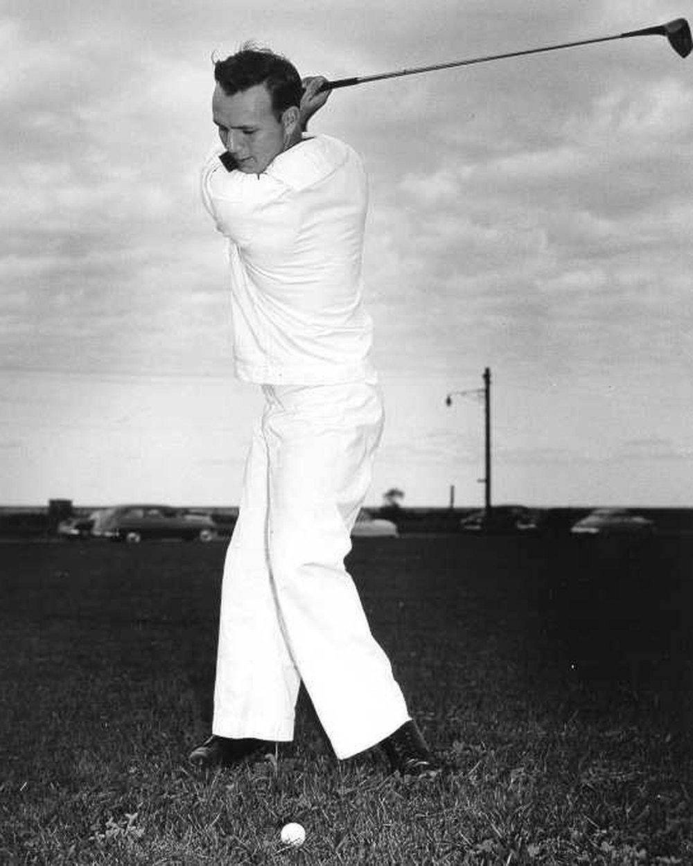 Arnold Palmer swinging in all white in 1953