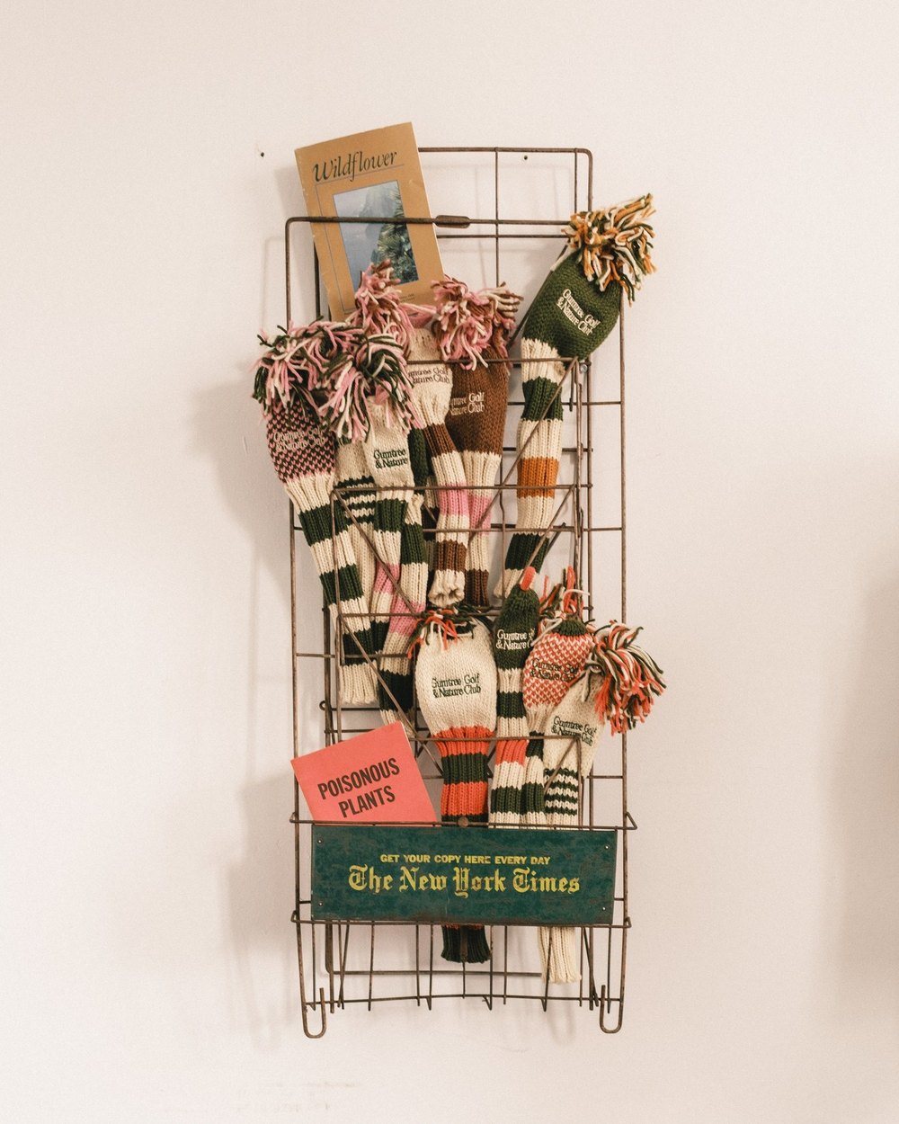 Gumtree&rsquo;s striped wool headcovers hanging on a wire newspaper rack