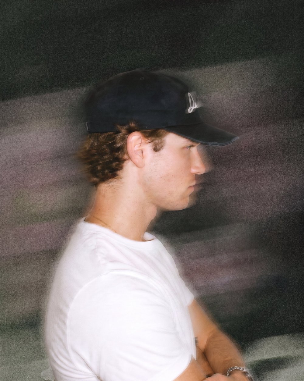 A man in a black Orién cap, blurred in motion