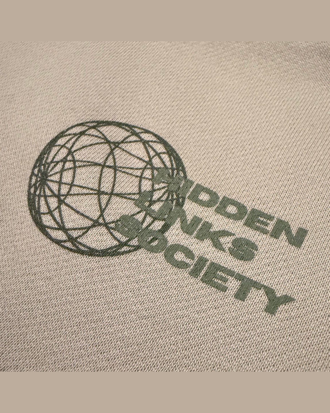 Beige garment-dyed hoodie with World Wide Golf print &middot; view 3 of 3