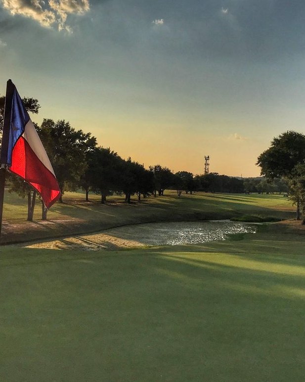 Texas flag over Lions Municipal at golden hour