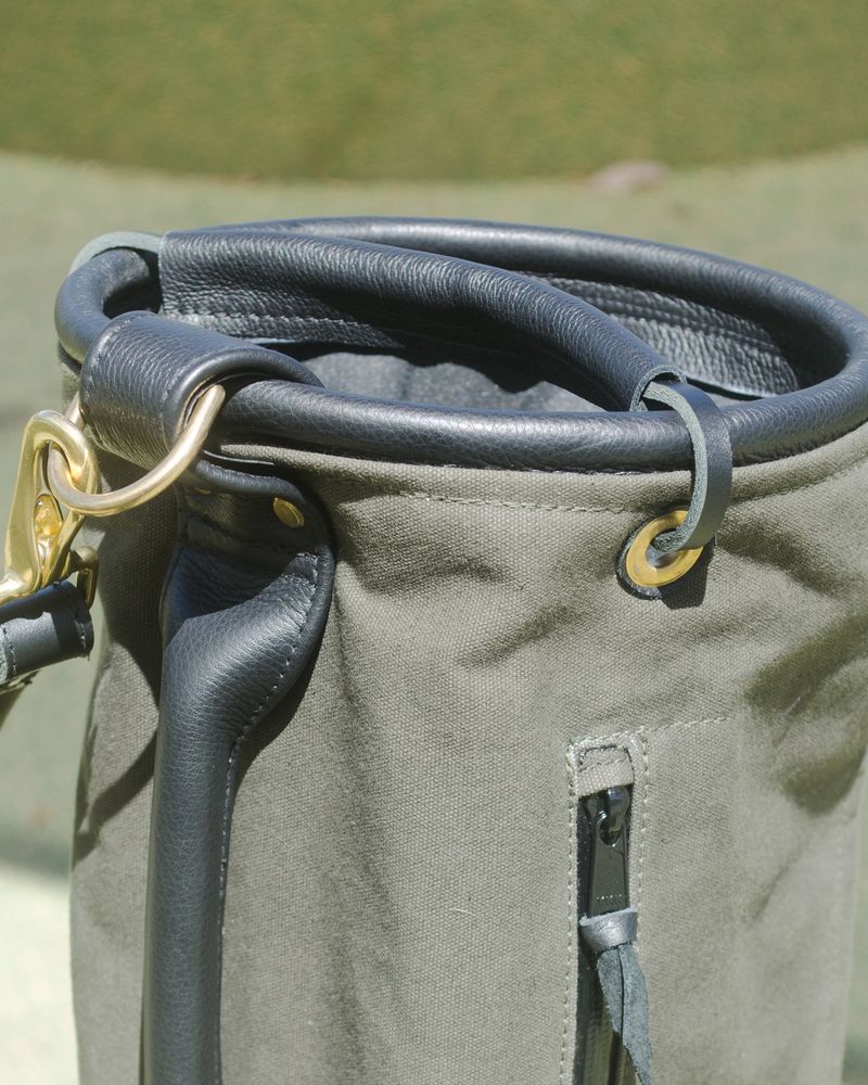 The leather-wrapped stainless steel hoop at the top of a Local GC Sunday bag