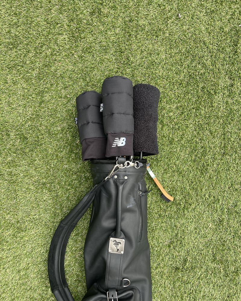 Black headcovers made from the jacket on clubs in a carry bag