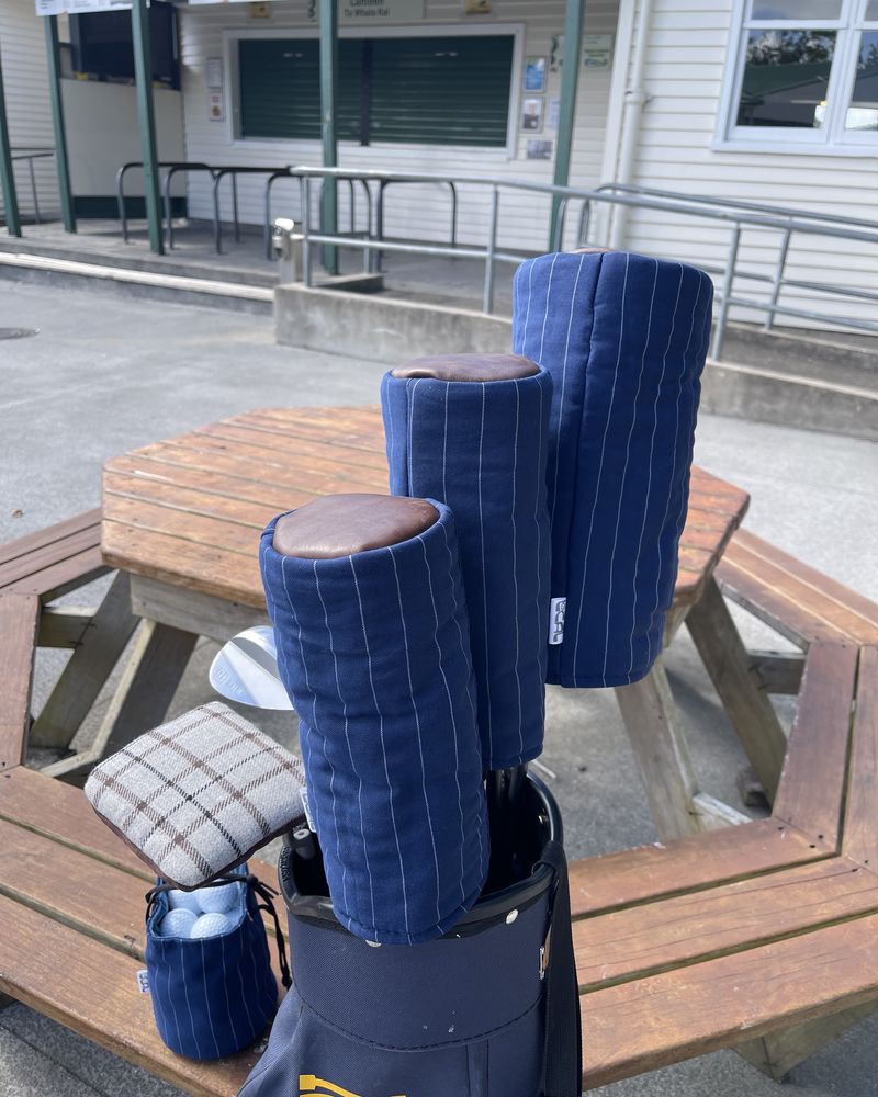 Navy pinstripe headcovers made from suit trousers on a bench